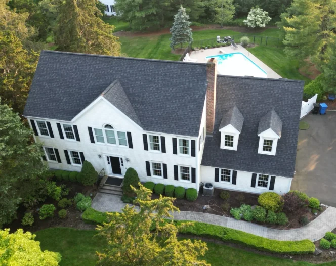large house with dark grey roofing HOME